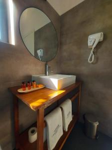 a bathroom with a sink and a mirror and towels at Casa das Portas in Azinhaga
