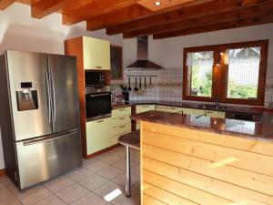 a kitchen with a stainless steel refrigerator and cabinets at Chalet Samoëns, 5 pièces, 14 personnes - FR-1-624-7 in Samoëns