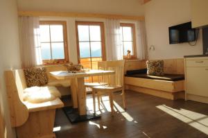 a kitchen with a sink and a table and chairs at Gerlhof in Obernussdorf