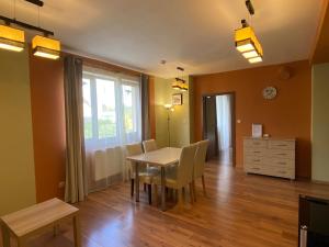 a dining room with a table and chairs and a dresser at Apartment Piknik in Stará Lesná