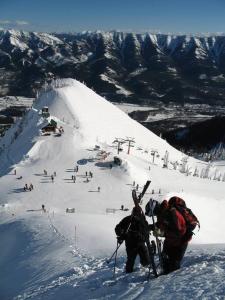 two people standing on a snow covered ski slope at The Qanuk Fernie - Ski In Ski Out in Fernie