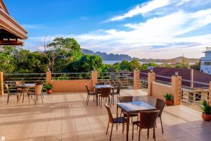 a patio with tables and chairs on a balcony at Dianna’s Inn in Coron