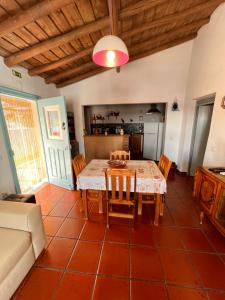 a dining room with a table and a couch at Casa da Eira in Reguengos de Monsaraz
