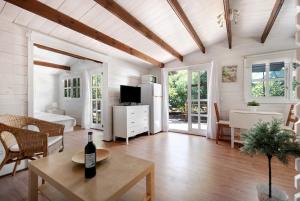 a living room with a couch and a table at Cottage Hibiscus among Avocados in La Orotava