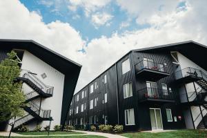 a black and white building with two balconies at Sleepover 1BD 1BA Downtown Bowling Green Apartments in Bowling Green