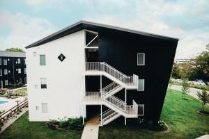 a white building with stairs on the side of it at Sleepover 1BD 1BA Downtown Bowling Green Apartments in Bowling Green