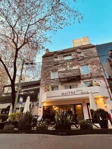 a building with umbrellas in front of it at Maitre Hotel Boutique in Buenos Aires