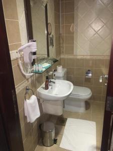 a bathroom with a sink and a toilet at Sky View Hotel, Madinah in Medina