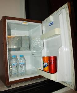 an open refrigerator with bottles of water and a soda at Majorel Pearl Hotel-Riad-Restaurant Piscine&Spa in Marrakesh