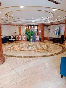 a large lobby with a large rug on the floor at Sky View Hotel, Madinah in Medina