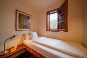 a bedroom with two beds and a window at Casa Margarita 4 in Mala +2 photos
