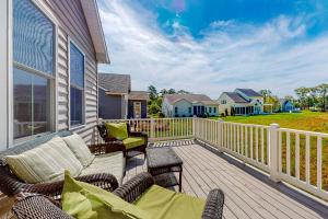 a deck with chairs and a couch on a house at Grande at Canal Pointe 37484 Liverpool Ln in Rehoboth Beach