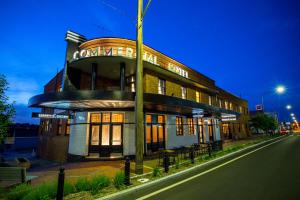 a building on the side of a street at night at The Commercial Boutique Hotel in Tenterfield