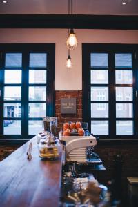 a bar with a table with food and glasses at The Commercial Boutique Hotel in Tenterfield