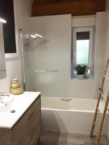 a bathroom with a white tub and a sink at Getxo Garden Houses - The Suite in Getxo