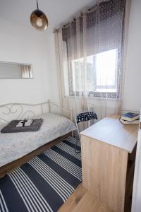 a bedroom with a bed and a window at Apartman "Stay In" Osijek in Osijek