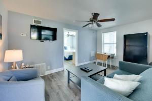 a living room with two blue chairs and a table at Silver Sands in St Pete Beach