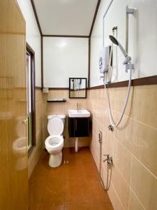 a bathroom with a toilet and a sink at Pavalintang Resort in Semporna