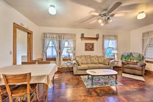 a living room with a table and a couch at Cozy Marlinton Home Fish, Hunt and Ski Nearby! in Marlinton