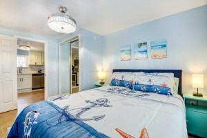 a bedroom with a large bed with blue walls at Sarasota Home with Screened Porch, Walk To Zoo! in Sarasota