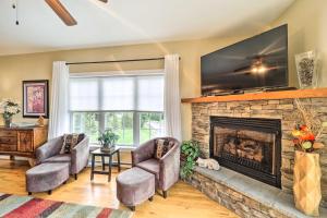 a living room with two chairs and a fireplace at Scenic Views! Ski-In/Ski-Out Condo in Beech Mtn in Beech Mountain