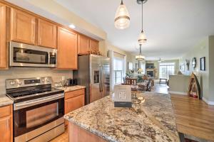 a kitchen with stainless steel appliances and wooden cabinets at Scenic Views! Ski-In/Ski-Out Condo in Beech Mtn in Beech Mountain