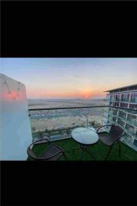 a view of a balcony with a table and chairs at Celestia by Damac Top view apartment in Dubai