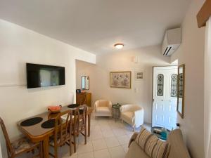 a living room with a table and a dining room at Sofia’s House in Pramanta