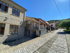 a cobblestone street in front of a building at Sofia’s House in Pramanta