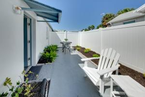 a patio with two white chairs and a table at Silver Sands in St Pete Beach