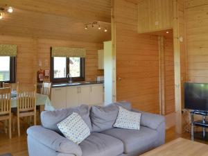 a living room with a couch and a kitchen at Dalch - Uk12538 in Witheridge