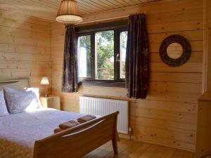 a bedroom with a bed and a window at Dalch - Uk12538 in Witheridge