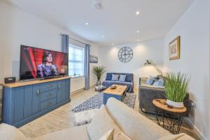 een woonkamer met een bank en een flatscreen-tv bij No2 Ellington Court Apartment in Torquay