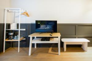 a desk with a chair and a computer on it at Hôtel du Jardin - Par Les Lofts Vieux-Québec in Quebec City