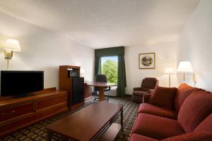 a living room with a couch and a tv at Baymont by Wyndham Crossville in Crossville