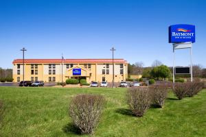 a large yellow building with a sign in front of it at Baymont by Wyndham Crossville in Crossville