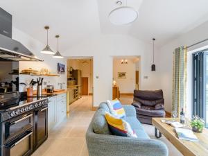 a kitchen and living room with a couch and a table at Temple House in West Burton