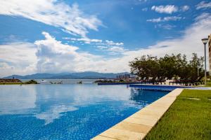 a swimming pool with a view of the water at Eurobuilding Hotel & Suites Lecheria in El Morro de Barcelona