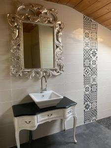 a bathroom with a sink and a mirror at Maison d'Emmannaelle in Auros