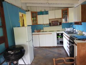 a kitchen with white cabinets and a refrigerator at Silver Hill Select in Spa Spring