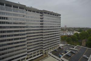a tall building with a parking lot in front of it at Amazing Central Southend,2-bedroom flat,10th floor in Southend-on-Sea