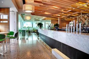 a restaurant with a bar with chairs and tables at Walkers Arms Hotel in Adelaide