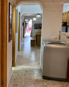 a hallway leading to a kitchen with a dishwasher at Apartamentos Primavera in Jardin