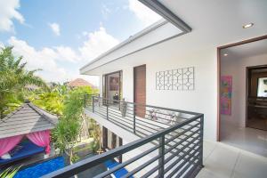 a balcony with a view of a house at Villa Penelopy in Seminyak