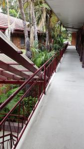 a walkway with a red railing next to a building at Flinders Motel in Wollongong