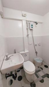 a bathroom with a toilet and a sink at Manila 1BR Cozy Homestay near UST/San Lazaro in Manila