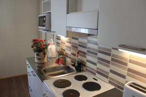 a kitchen with a stove and a sink at Holiday Home Kokki in Rovaniemi