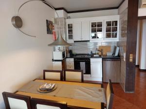 a kitchen with a dining table and a kitchen with white cabinets at Albufeira Paradise in Albufeira