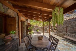 a wooden table and chairs on a patio at Redondo de Guayedra in Guayedra