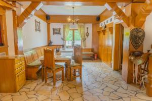 a dining room with a table and chairs at Popasul Craiului in Zărneşti